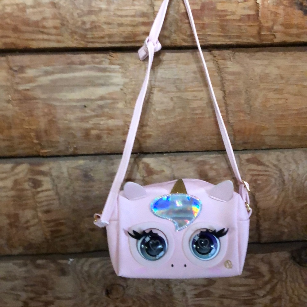 Pink unicorn purse. Eyes blink and makes a sound